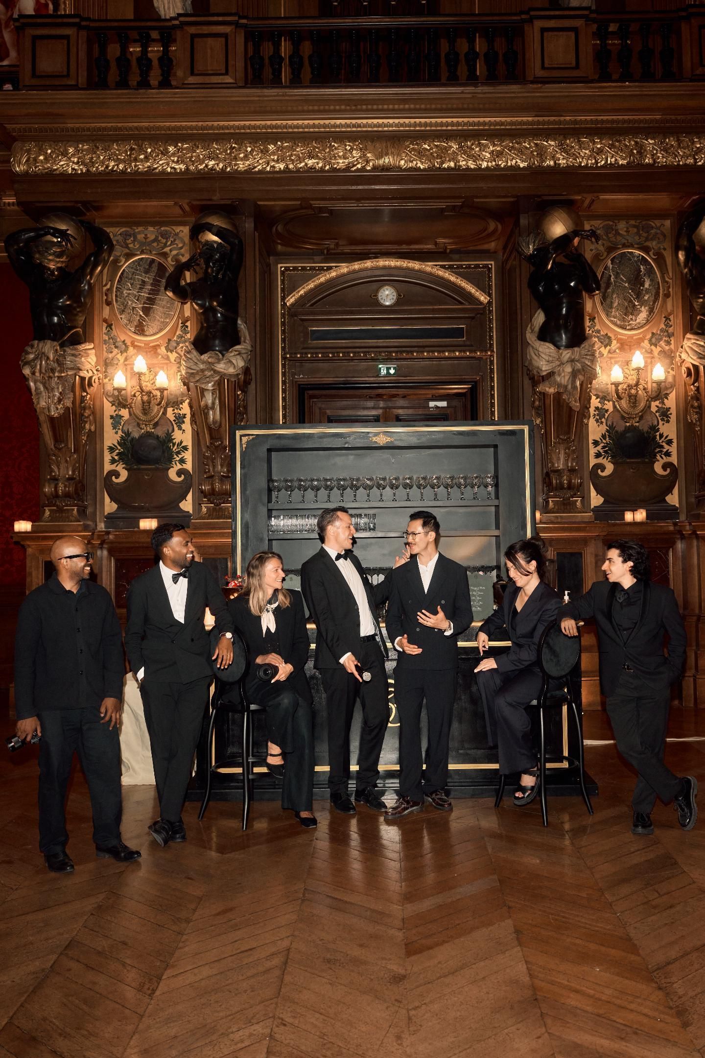 Naïm Terrache with the event team in an ornate wood-panelled room